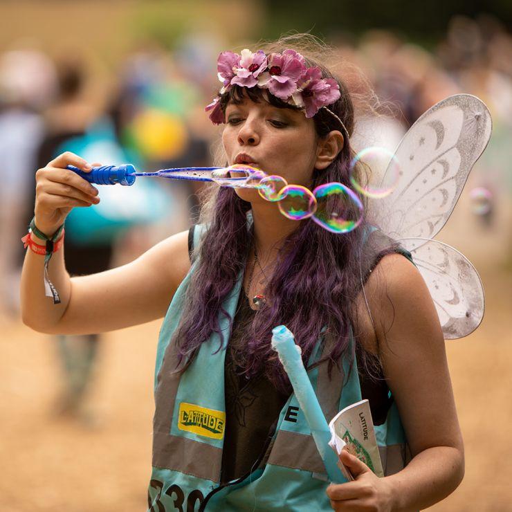 Festival Volunteers and Stewards - Hotbox Events - Pixie volunteer with wings blowing bubbles - 2022-001 740PxSq72Dpi